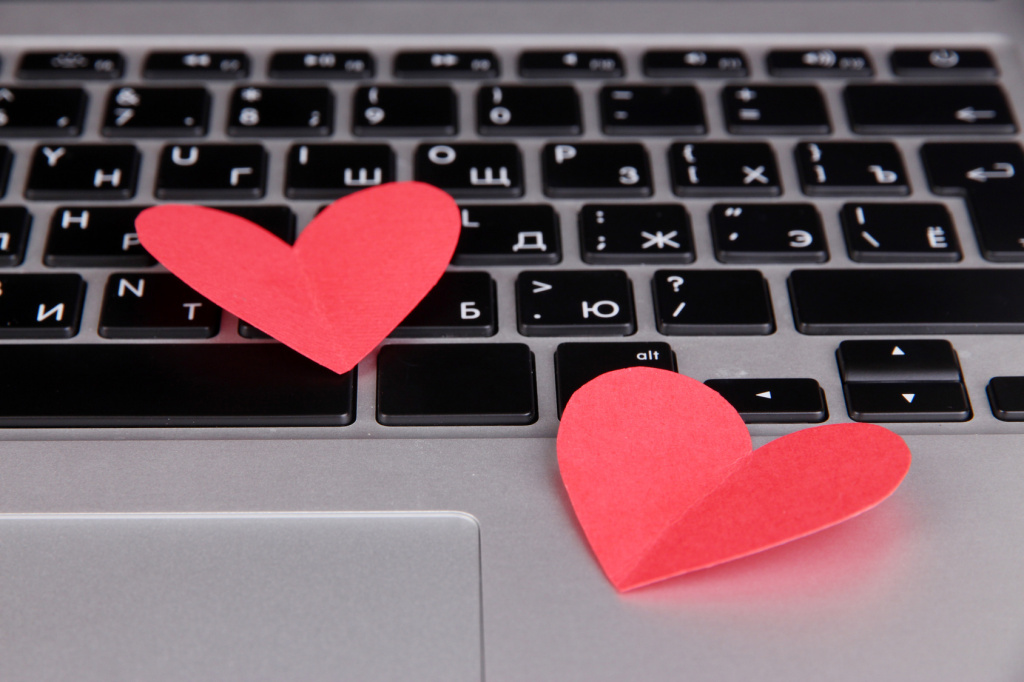 Red hearts on computer keyboard close up