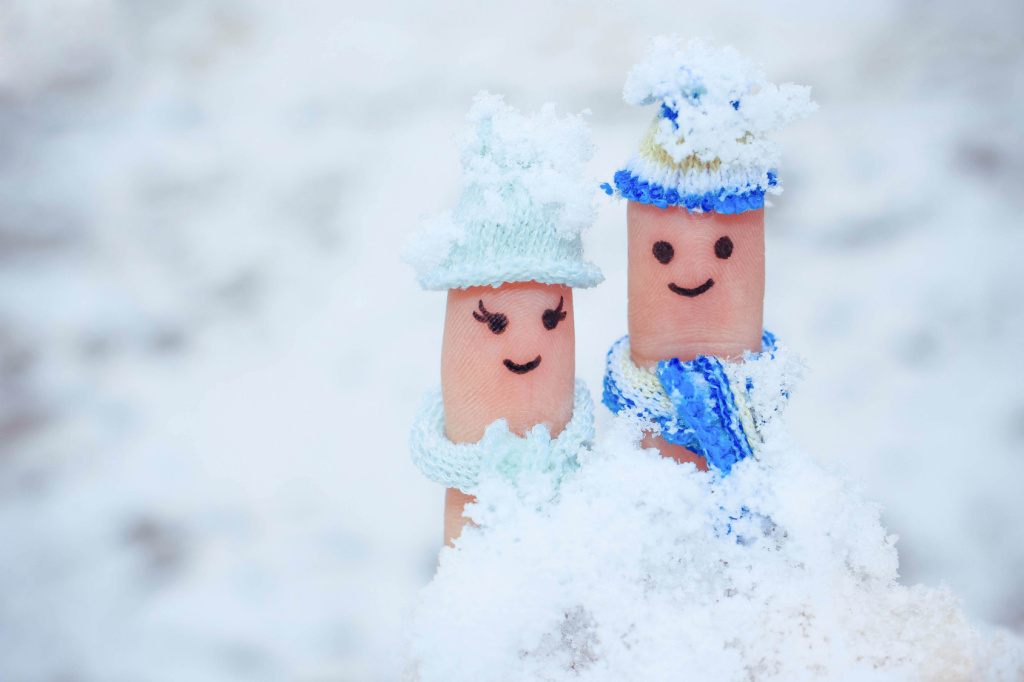Finger art of a Happy couple on the background of snow.