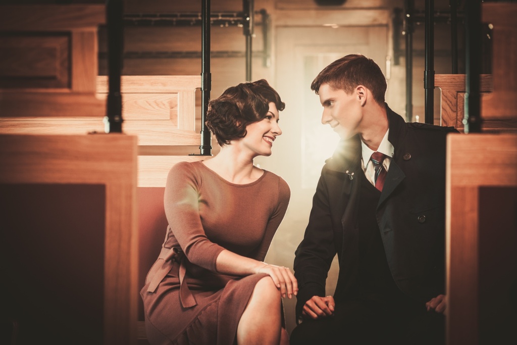 Vintage style couple inside retro train coach