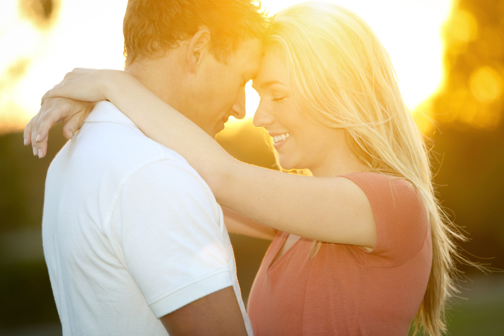 Loving young couple in glowing sunlight